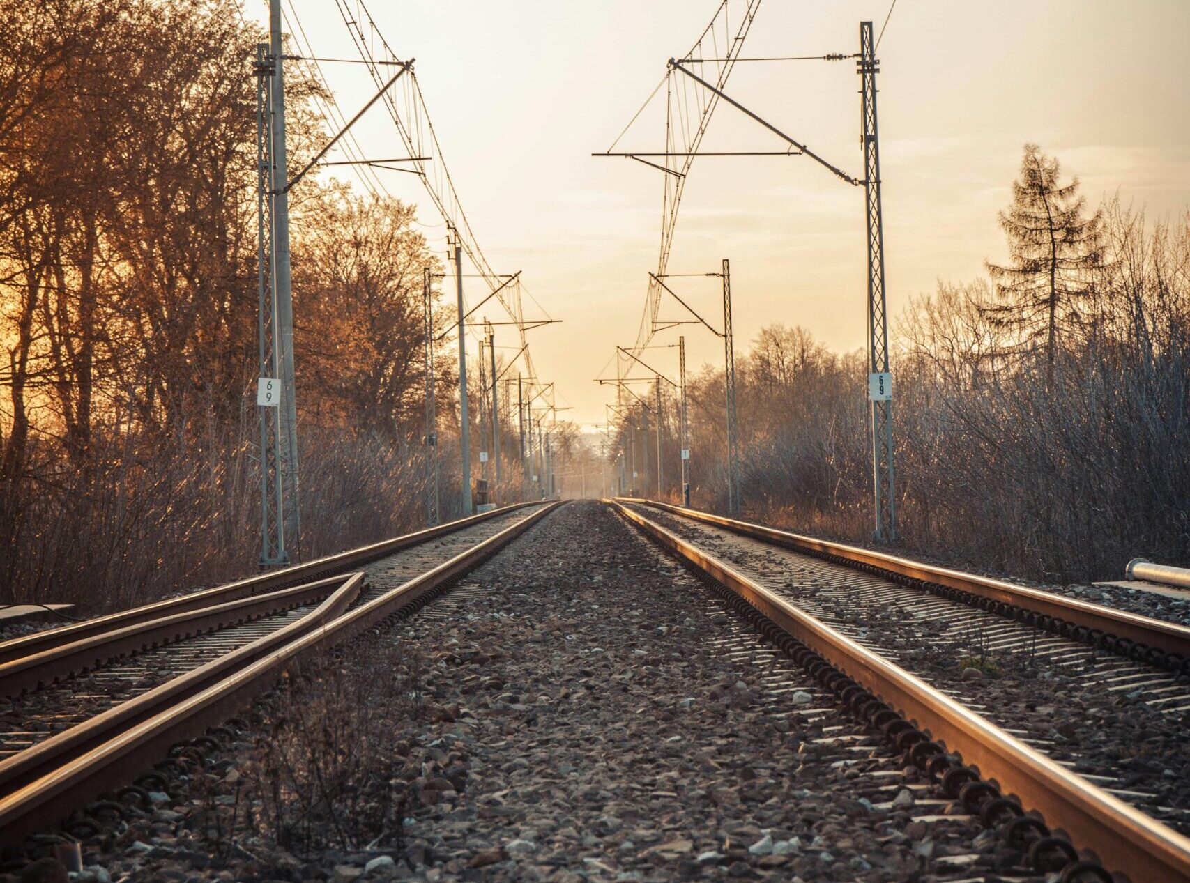 Peaceful railway scene during sunset in Kraków, Poland.